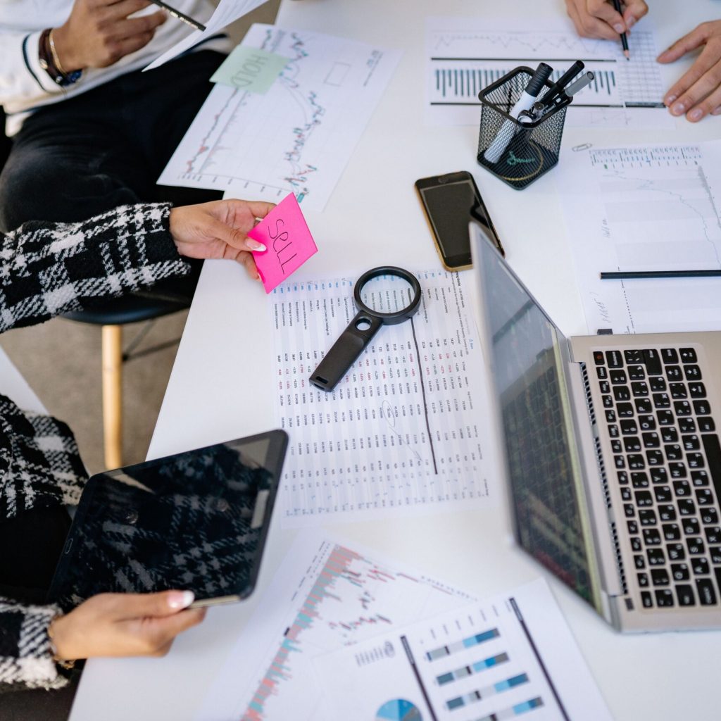 Business professionals collaborating on financial data analysis in a modern office setting.